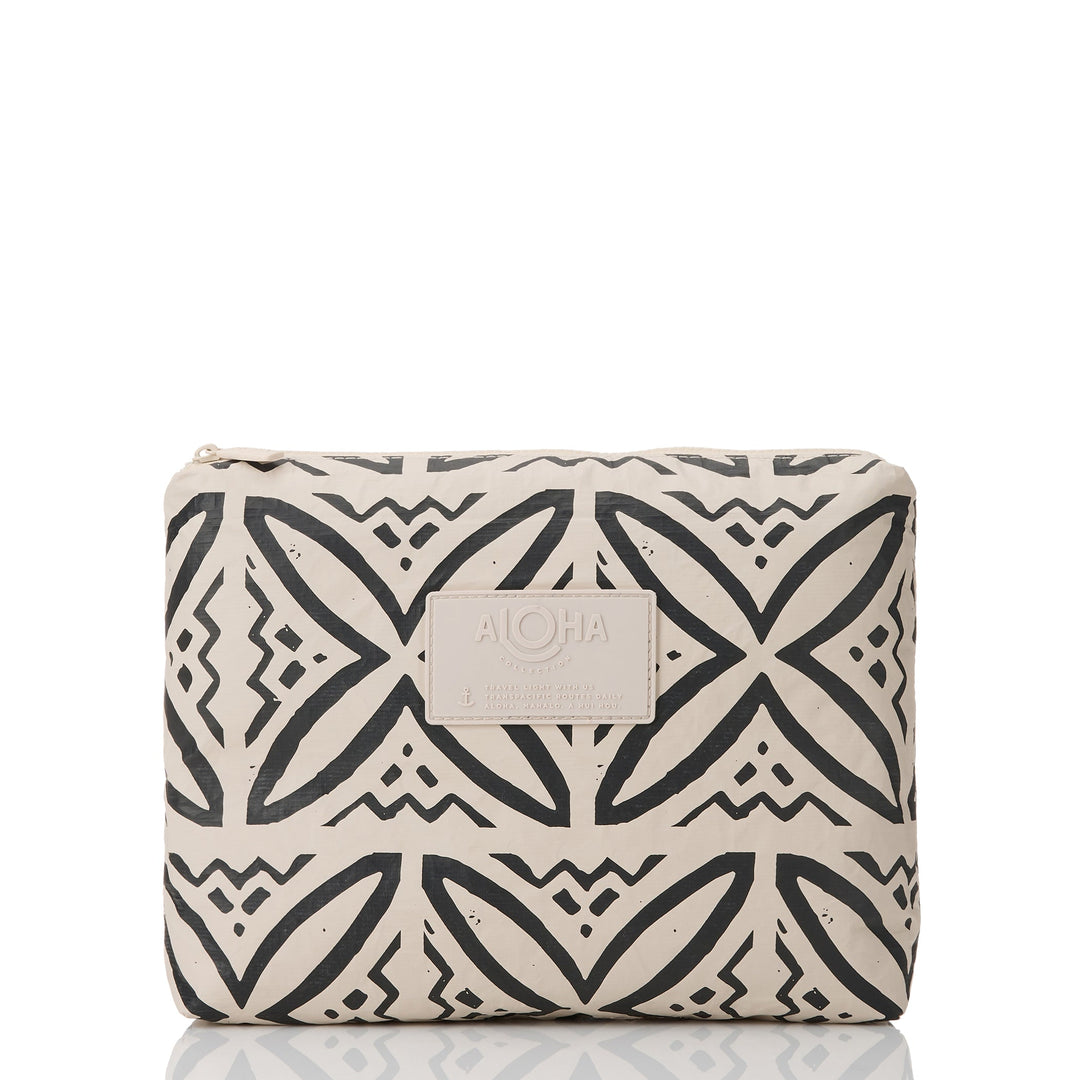 Sandstone-colored Pasifika Mid Pouch with a bold black geometric print and tan ALOHA patch, front view
