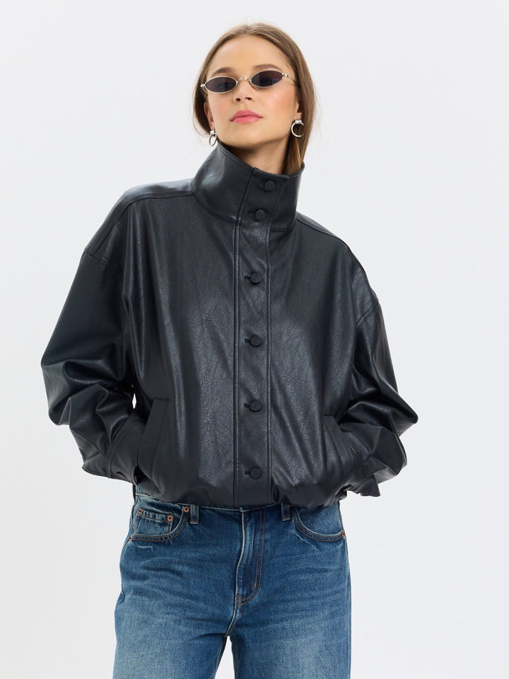 Daze Denim Phantom Faux Leather Funnel Neck Jacket in Black — front view zipped up, styled with blue jeans | Jayden P Boutique