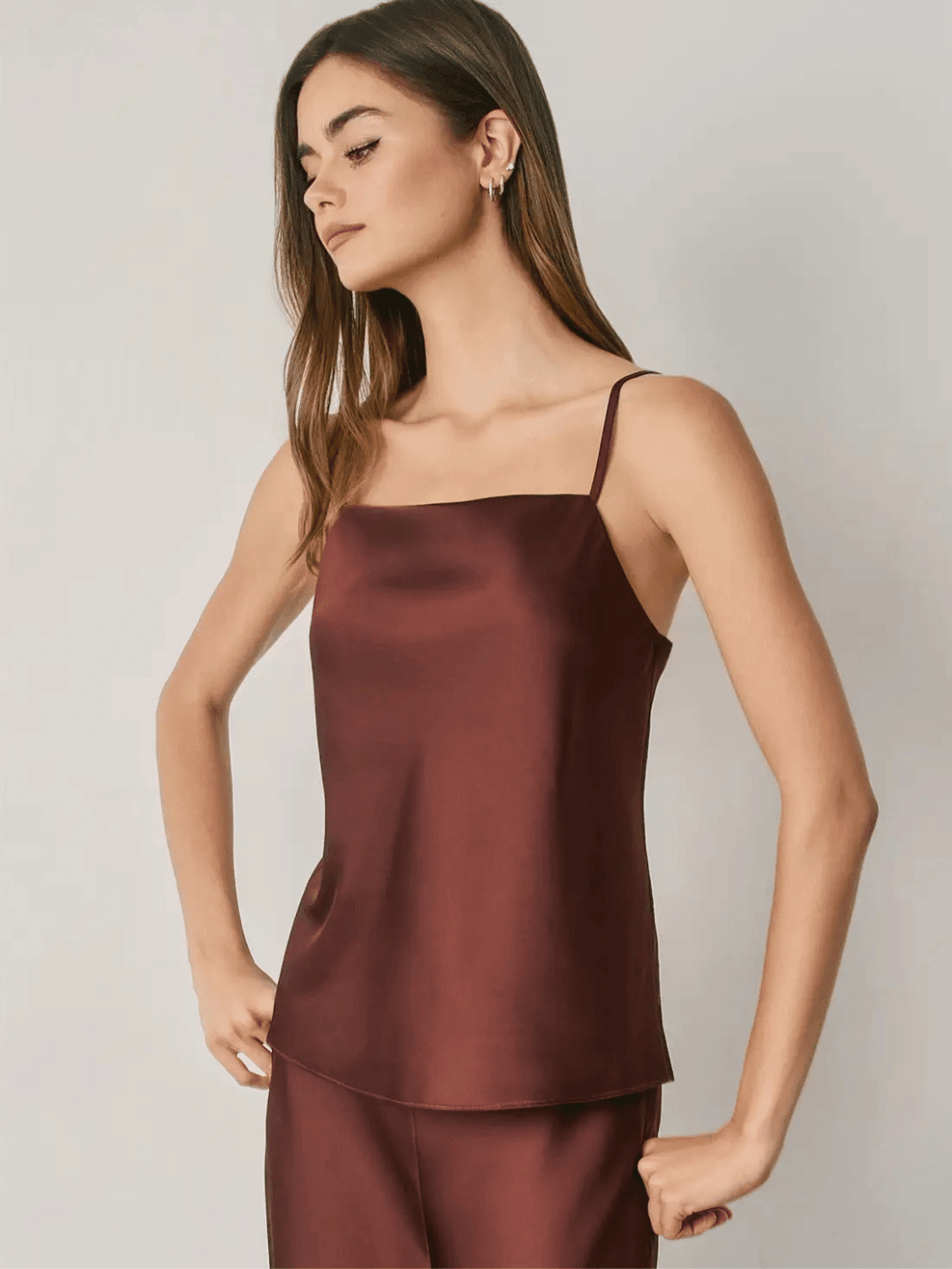 Women's burgundy satin cami top with square neckline and adjustable spaghetti straps.
