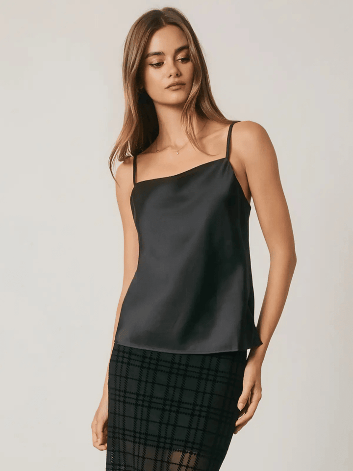 Black satin camisole with square neckline and adjustable straps styled with plaid skirt