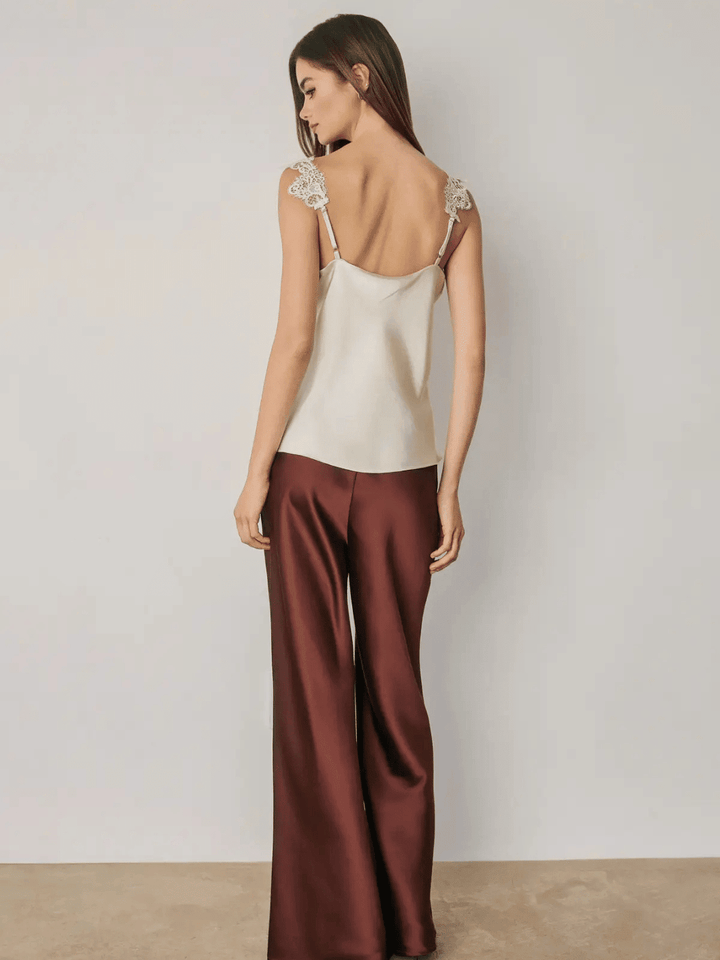 Women wearing red satin straight leg pants with lace detail camisole.