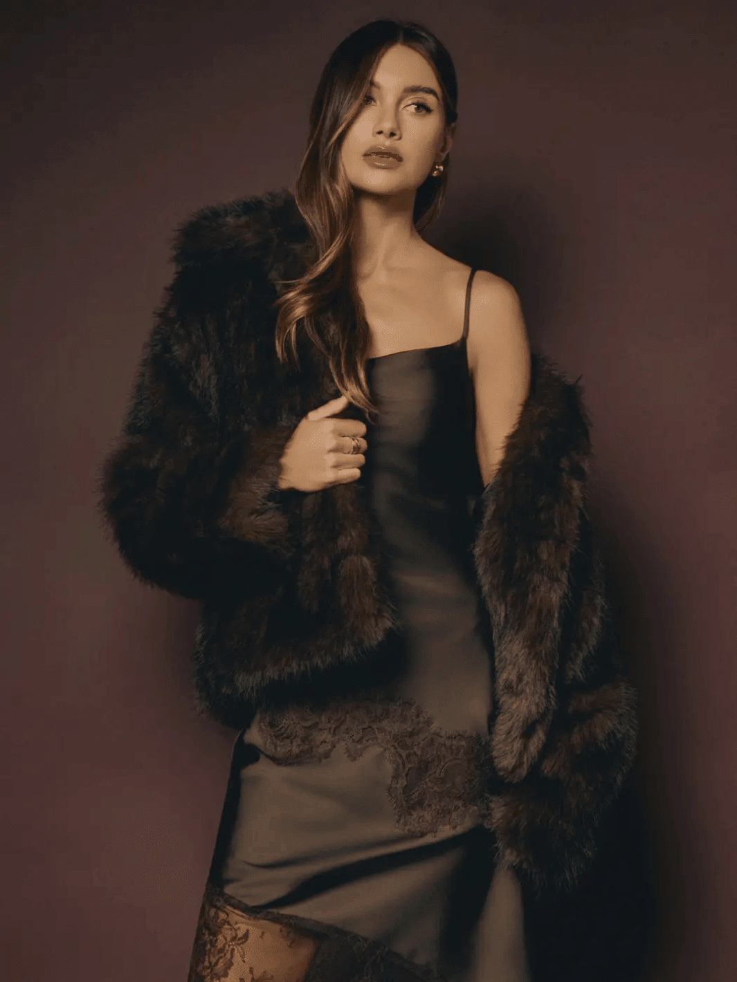 The Mocha Cloud Faux Fur Jacket in Chocolate by Jayden P Boutique, styled over a black satin slip dress on a dark studio background.