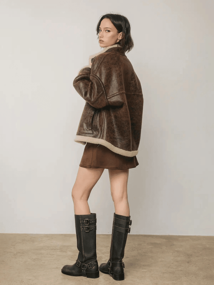 Back view of The Renegade Shearling Moto Jacket from Jayden P Boutique, showing oversized distressed brown fit and sherpa trim.
